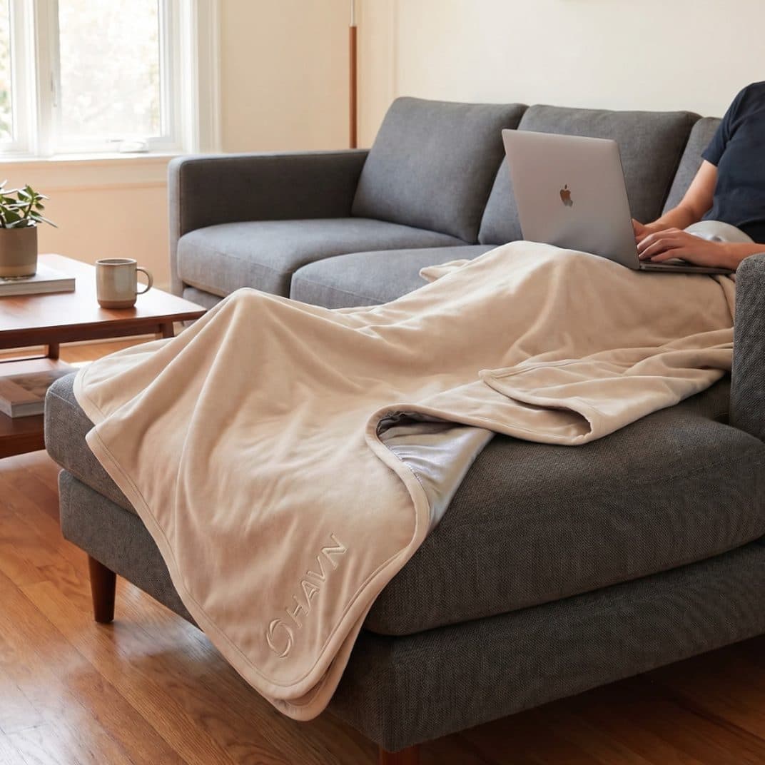 The HAVN WaveStopper blanket draped over a sofa in a living room.